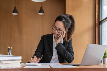 Fototapeta premium Busy business accountant woman making call phone in office and business working background, tax, accounting, statistics and analytic research concept