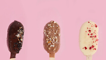 Popsicle ice-cream assortment on pink background.