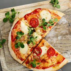 Margherita pizza on gray background.