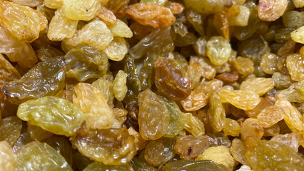 Natural background with dried yellow golden raisins
