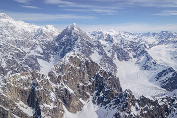 Expansive views of the snow and ice covered mountains in the Alaska Range