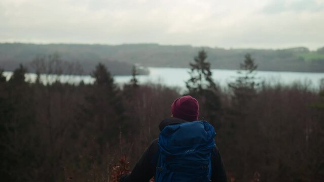 Tourist with Backpack Enjoys the View of Lake in Himmelbjerget Area, Denmark