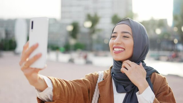 Muslim woman in hijab posing grimacing in front of her mobile