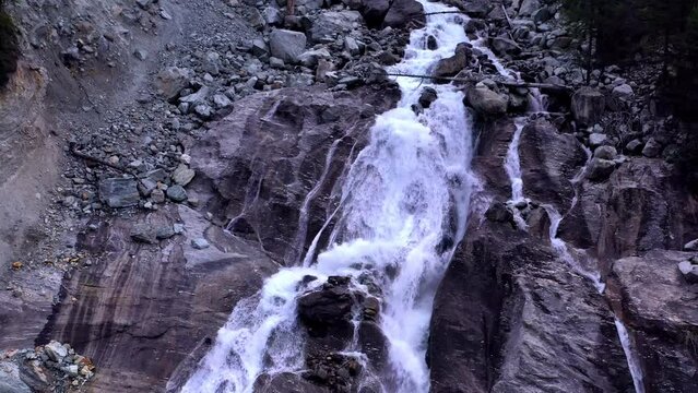 Drone flight from Zinal valley towards the river flowing down from Weisshorn (4505m) in Valais, Switzerland