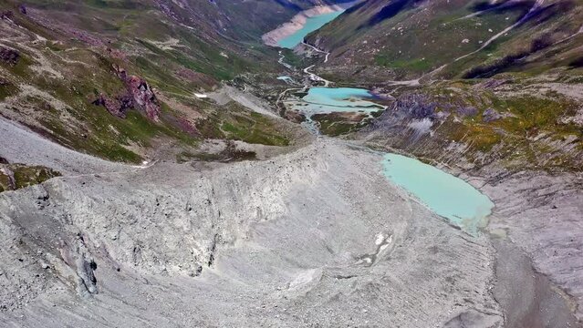 Drone flight from Moiry glacier towards Moiry reservoir and dam in Valais Switzerland