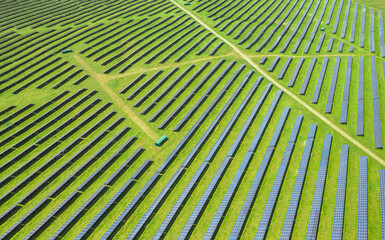 Aerial texture view with a big solar panel plant on top of the hills. Summer industrial landscape...