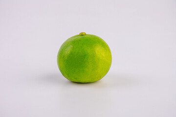 Lime with green leaf isolated on white background.