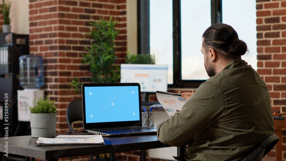 Poster office worker using laptop with greenscreen display at job, working with isolated blank template and