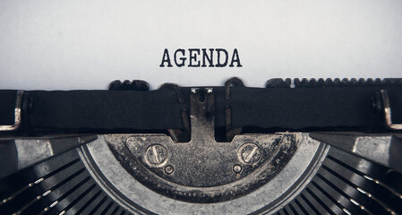 Agenda text typed on an old vintage typewriter. Conceptual