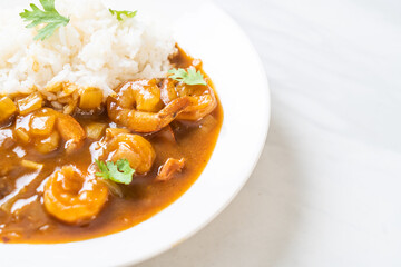 Shrimps in curry sauce on rice