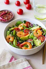 Salad with shrimps, avocado, tomatoes, onions and seeds. Healthy eating. Diet.