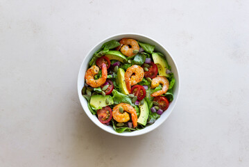 Salad with shrimps, avocado, tomatoes, onions and seeds. Healthy eating. Diet.