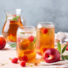 Fototapeta na wymiar Peach raspberry iced tea, summer refreshing drink, beverage, cocktail