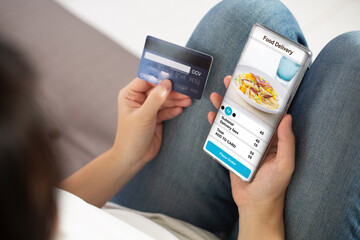 Women during confirm food delivery online order using mobile phone smartphone at home. Person using smartphone order food from restaurant to home front door. concept