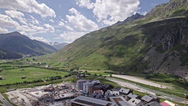 Beautiful aerial view of Swiss mountain village Andermatt, Canton Uri, on a sunny summer day. Movie shot July 3rd, 2022, Andermatt, Switzerland.