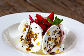 Sweet dessert, Pavlov's cake with butter cream and strawberries. Soft focus background, a place for text