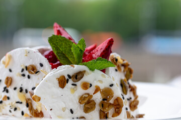 Sweet dessert, Pavlov's cake with butter cream and strawberries. Soft focus background, a place for text