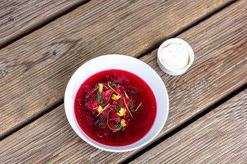 Vegetable cold soup with beet, cucumber, radsih and egg on wooden table