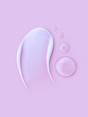 cosmetic smears cream texture on pastel pink background	
