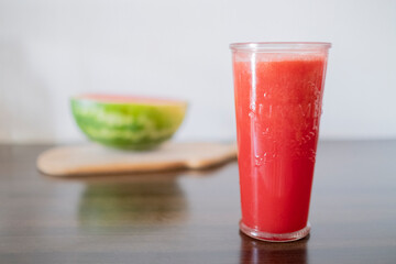 Watermelon smoothie in glass on wood table. summer refreshment, healthy drink.