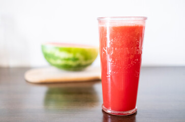 Watermelon smoothie in glass on wood table. summer refreshment, healthy drink.