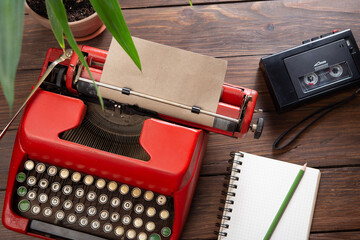 Journalism or blogging concept - vintage typewriter on the wooden desk, top view