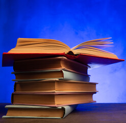 Wisdom and education concept.Book on the table, love reading. Retro neon light 90s