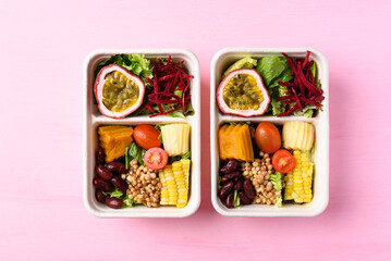 Fresh vegetables salad in biodegradable bowl on pink background, Healthy vegan food