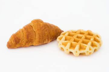 Croissant and waffles isolated on white background.