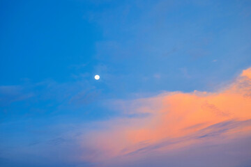 Vivid sky with fullmoon in sunset against blue sky background