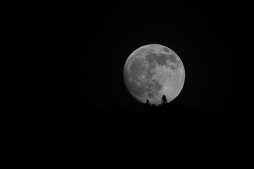 Fototapeta na wymiar Full moon in this beautiful dark space 