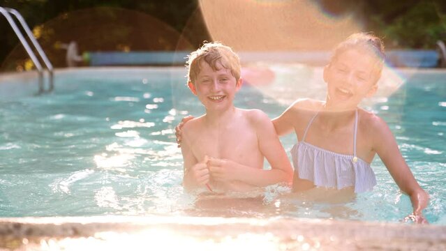 Two Kids Boy and Girl Having Fun in the Pool. Summer Vacation Concept