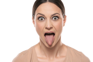 Woman with funny face mocking someone sticking her tongue out