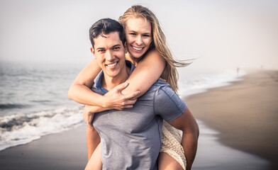 Couple portrait in a foggy day on the beach