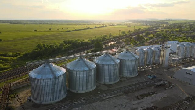 Aerial view of industrial ventilated silos for long term storage of grain and oilseed. Metal elevator for wheat drying in agricultural zone