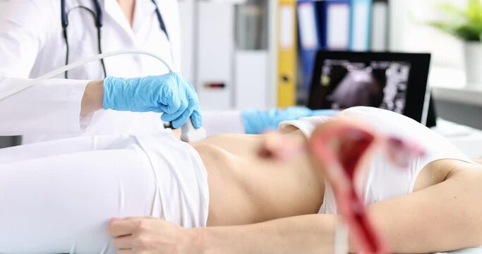 Doctor makes 3d ultrasound of female reproductive system of woman in clinic