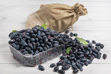 Fresh blue pulp in a plastic box on a wooden background