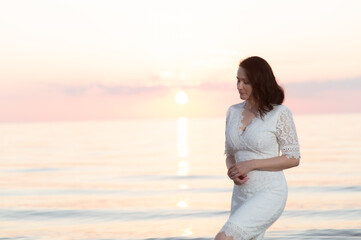 Portrait of a mature woman by the sea at sunset