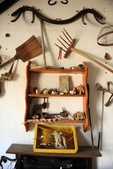 Corner with old farming tools inside a rural tourism house. Decoration with objects of nostalgia. Andalusia Spain