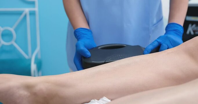 Laser hair removal on legs in beauty salon closeup
