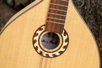 The national Greek string-plucked musical instrument Bouzouki close up.