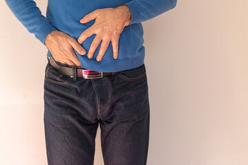 Stomach Ache. Sick mature man suffering from chronic abdominal pain at home,
