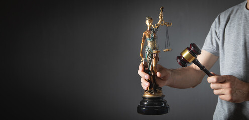 Lawyer or judge holding gavel and lady justice statue. Law and justice