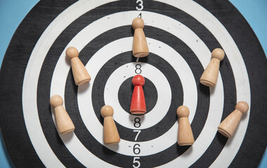 Wooden human figures on target dartboard. Target. Success. Business