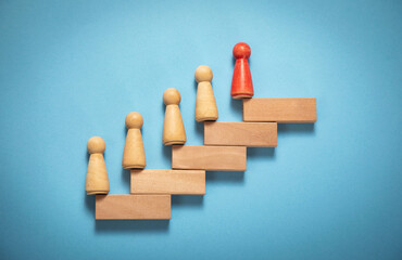 Wooden human figure in the stairs. Business. Career