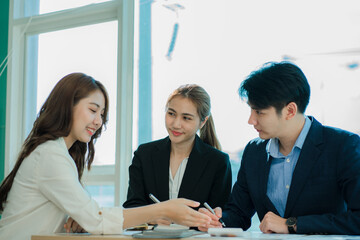 small group of young people at a business meeting a team in a modern office planning of work design and brainstorming ideas Hands of a businessman working on documents and laptops 