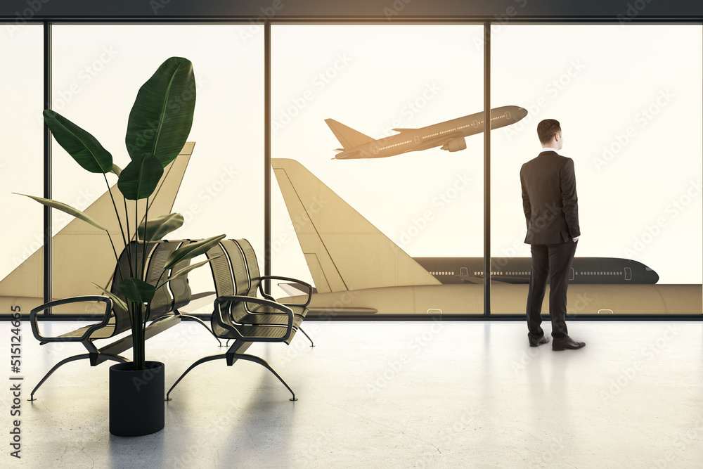Poster abstract backlit image of businessman looking out of window to look at airplane in airport. passenge