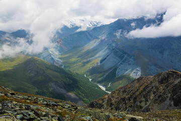 Aerial view over Altai mountains from Karaturek Pass on the way to Belukha mountain with blue sky with clouds. Altai region, Siberia, Russia