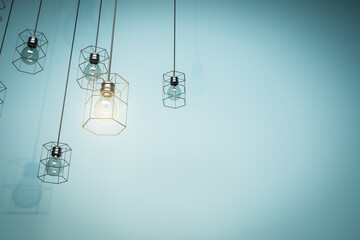 Creative lamps hanging on blue wall background with mock up place. Decoration and idea concept. 3D Rendering.