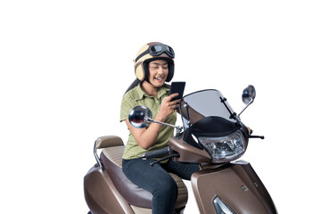 Fototapeta na wymiar Asian woman with a helmet sitting on a scooter while using a mobile phone